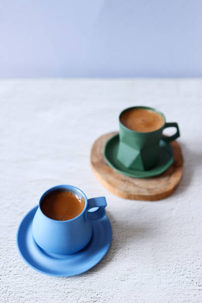 istock Sparkling Turkish coffee in a blue and green ceramic cup on a light gray concrete floor 1310757127