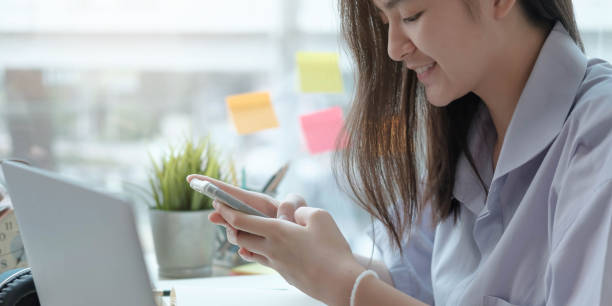 istock girl school student hold smartphone using distance learning mobile app online watching video course or zoom calling making notes in workbook sit at home. 1310757225