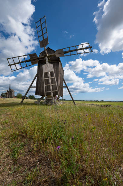 istock Old weathered windmill in Oland with clouds on a blue sky 1310758076