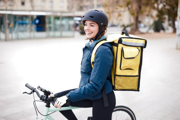 istock Female rider bicycle delivery person 1310759089