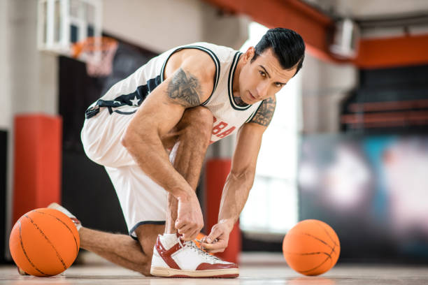 istock Young man with tatoo having a workout in gym and looking concentrated 1310761884