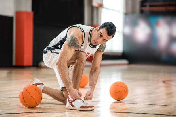 istock Young man with tatoo having a workout in gym and looking concentrated 1310761887