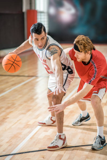istock Two young men playing basketball and feeling excited 1310761929