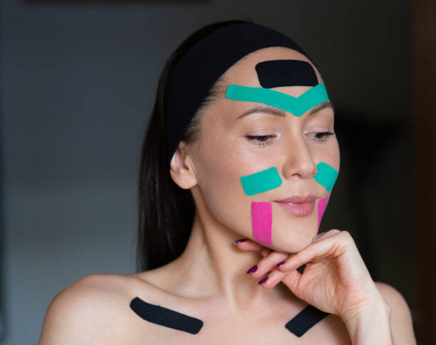 istock face taping. woman looking in the mirror. 1310763530