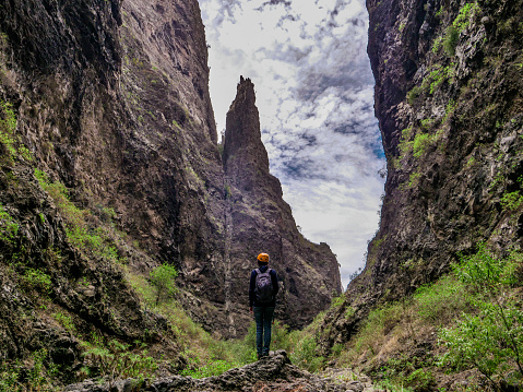 Hiker standing and looking to the impressive gorges of the ravine