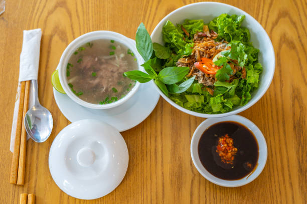 Delicious Vietnamese Pho bowl on wooden table background