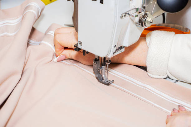 istock A seamstress, sewing a dress on a sewing machine. Close-up 1310764969