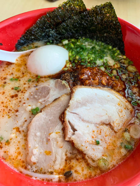 Closeup karaka spicy miso ramen with egg and chashu.