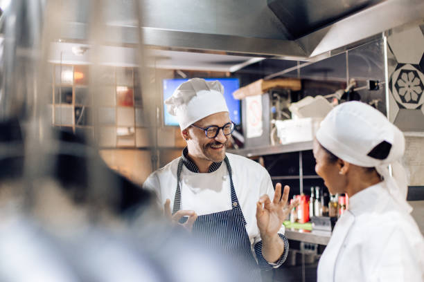 istock Chef is teaching his young cook at the restaurant 1310767751