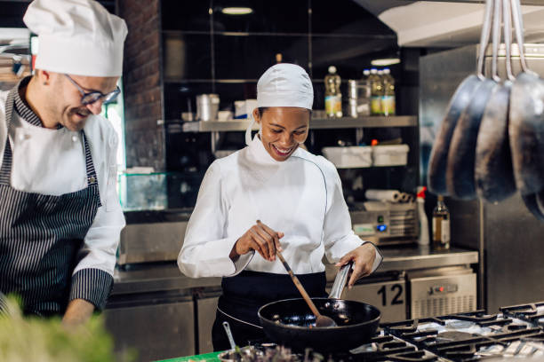 istock Young cook working with her chef at the restaurant 1310767752