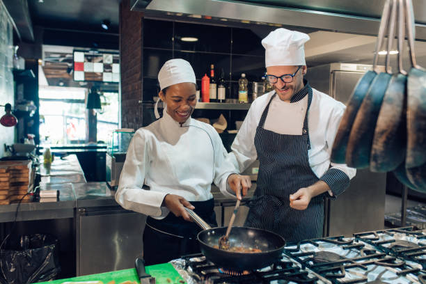 istock Young woman learning to cook from the experienced chef 1310767763
