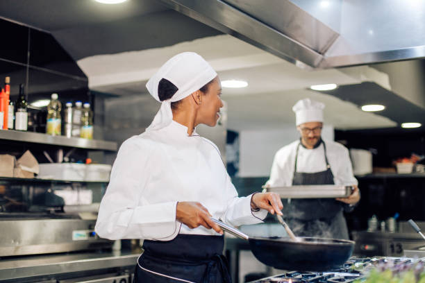 istock Young female cook and her chef working at the restaurant 1310767764