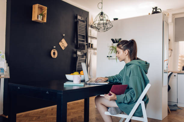 istock Beautiful student learning for her exam at home 1310768367