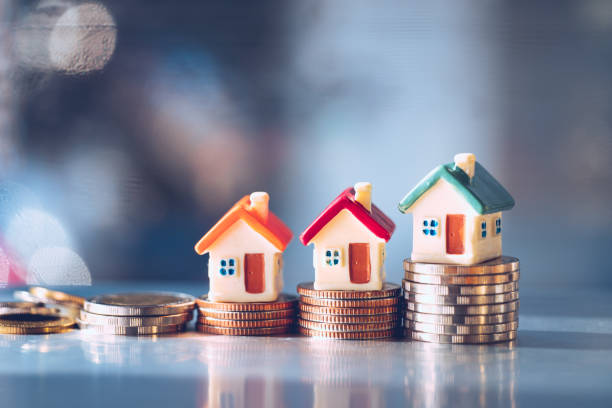 Miniature colorful house on stack coins Miniature colorful house on stack coins using as property real estate and financial concept housing development stock pictures, royalty-free photos & images