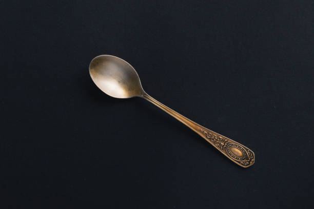 istock Old silver teaspoon on a black background. Vintage. Grunge. 1310770072