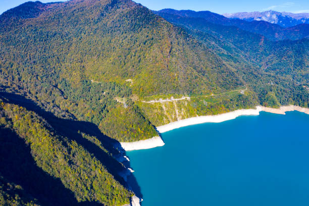istock Blue lake surrounded by mountains and forest 1310770890