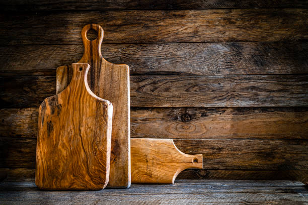 istock Cooking backgrounds: cutting boards on wooden table. Copy space. 1310772180