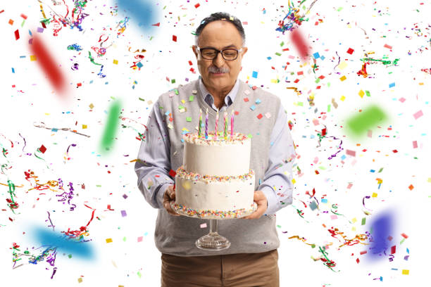 istock Mature man with a birthday cake 1310773028