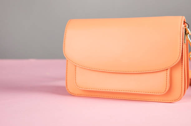 istock woman orange bag on table 1310773299