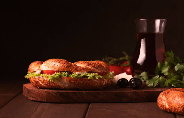istock Traditional Turkish bagel simit, breakfast, on a wooden table, rustic, horizontal, no people 1310774165
