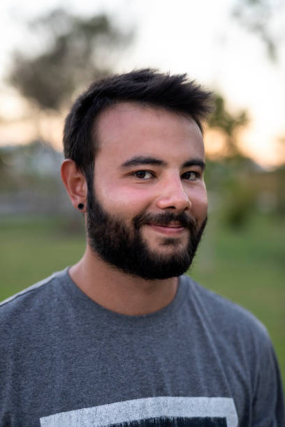 istock Cheerful young man in a local park 1310774610