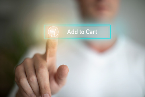 A Caucasian male pressing an add-to-cart button on a digital screen. on a digital screen.