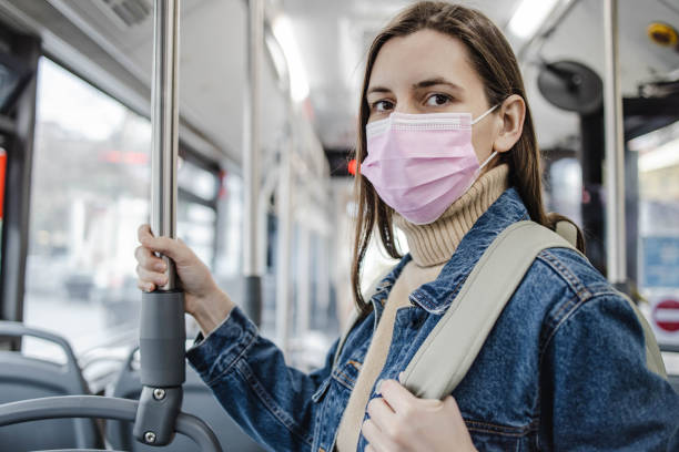 istock Woman with a protective face mask in a bus 1310775556