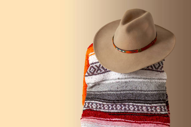 Cowboy hat and a Southwestern blanket with a beige background