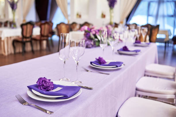 istock Table setting with white plates, flowers, wineglasses and cutlery on table, copy space. Menu mockup, place setting at wedding reception. Table served for wedding banquet in restauran 1310776406