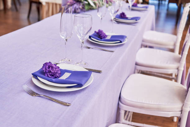 istock Table setting with white plates, flowers, wineglasses and cutlery on table, copy space. Menu mockup, place setting at wedding reception. Table served for wedding banquet in restauran 1310776408