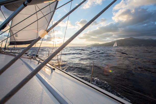istock Sailing at sunrise. Two sailing yachts are sailing at dawn. 1310776818