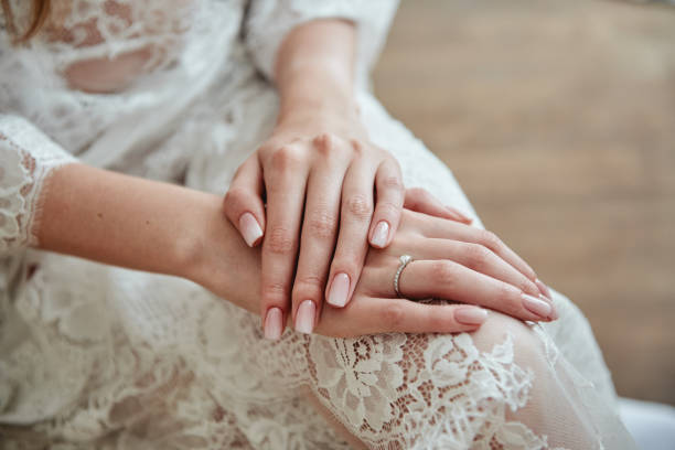Close up of woman hands with pastel wedding manicure, copy space stock photo