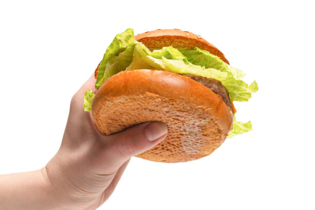 istock Hamburger in woman hands isolated on a white background. 1310780699