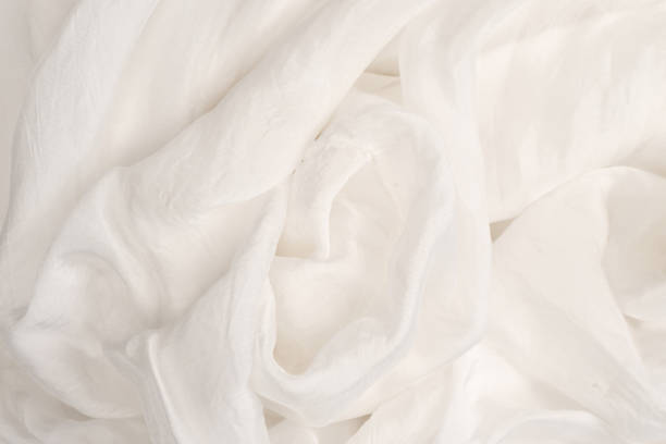 istock Soft smooth white silk fabric background. Fabric texture. 1310780750