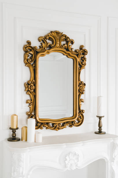 istock Old vintage mirror with gold colored wooden ornament frame. 1310781862