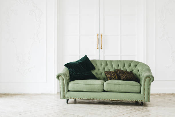 istock Green comfortable sofa in bright living room with minimalist interior. 1310781931