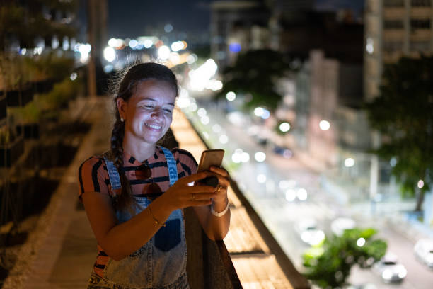 istock Woman using smartphone in urban nightlife 1310782093