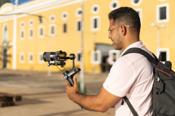 Woman using vintage video camera