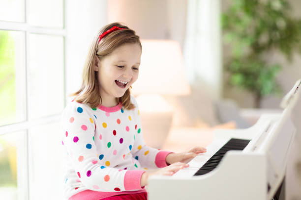 istock Child playing piano. Kids play music. 1310784463