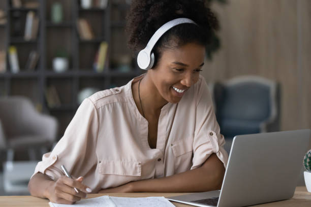 istock Smiling millennial biracial female study on laptop 1310784915