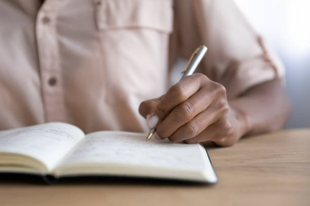 istock Close up of biracial woman write in notebook 1310784921
