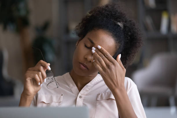 istock Tired biracial woman suffer from headache at workplace 1310784936