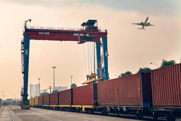 istock Airplane flying over an international container port. 1310786078
