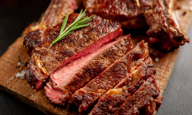 istock Beef steak, herbs and spices on a stone background 1310786124