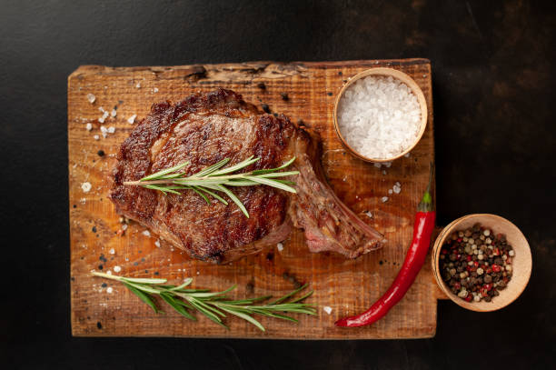 istock Beef steak, herbs and spices on a stone background 1310786145