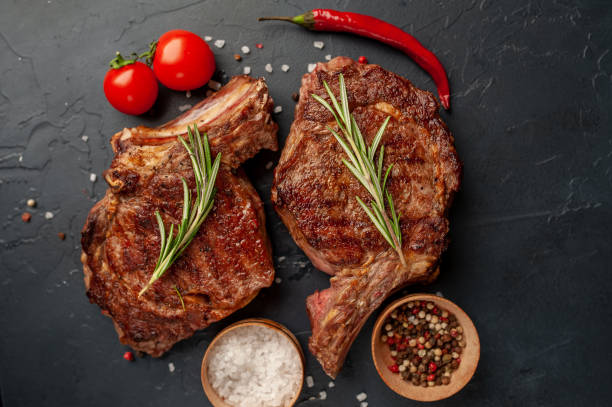 istock Beef steak, herbs and spices on a stone background 1310786149