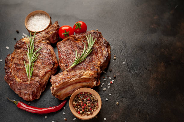 istock Beef steak, herbs and spices on a stone background 1310786803