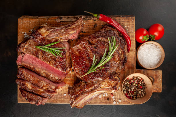 istock Beef steak, herbs and spices on a stone background 1310786986