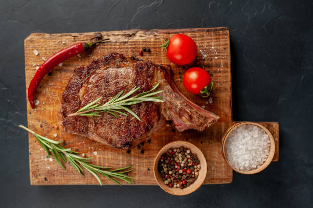 istock Beef steak, herbs and spices on a stone background 1310787009