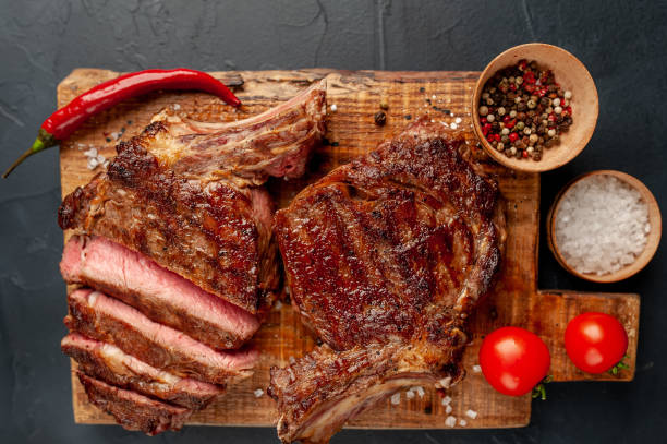 istock Beef steak, herbs and spices on a stone background 1310787031